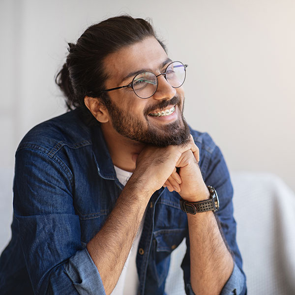 Man Smiling Indoors with Braces